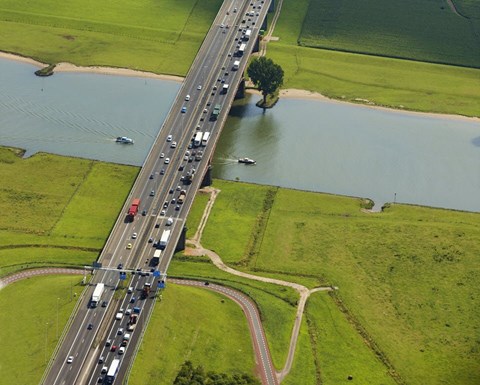 Road with traffic in a landscape with water