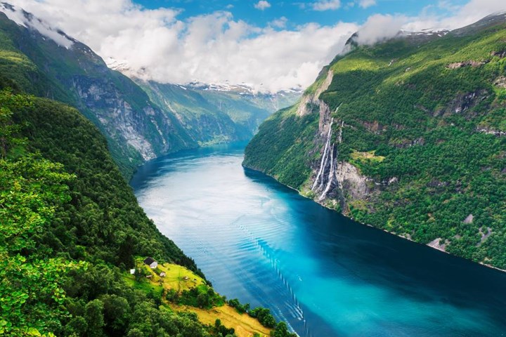 A fjord surrounded by mountains and waterfalls