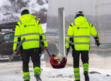 two workers carrying a bag on a consturction site