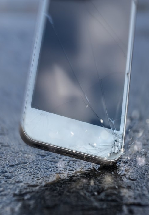 Cracked smartphone screen after drop-test on concrete floor