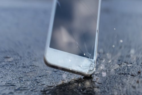 Cracked smartphone screen after drop-test on concrete floor