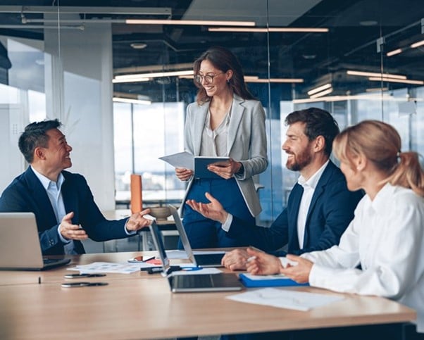 4 people in an office, having a project management meeting for wind power